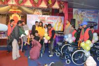 Swamiji distributing assistive devices and necessary equipments to differently abled people