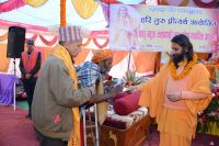 Distributing Necessary Materials to sadhus and batuks 